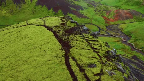 green craggy mountains revealed natural hot spring river bath in reykjadalur, iceland