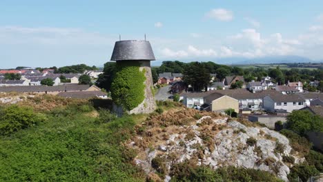 llangefni windmill ivy covered landmark aerial view pull back reveal rural welsh monument