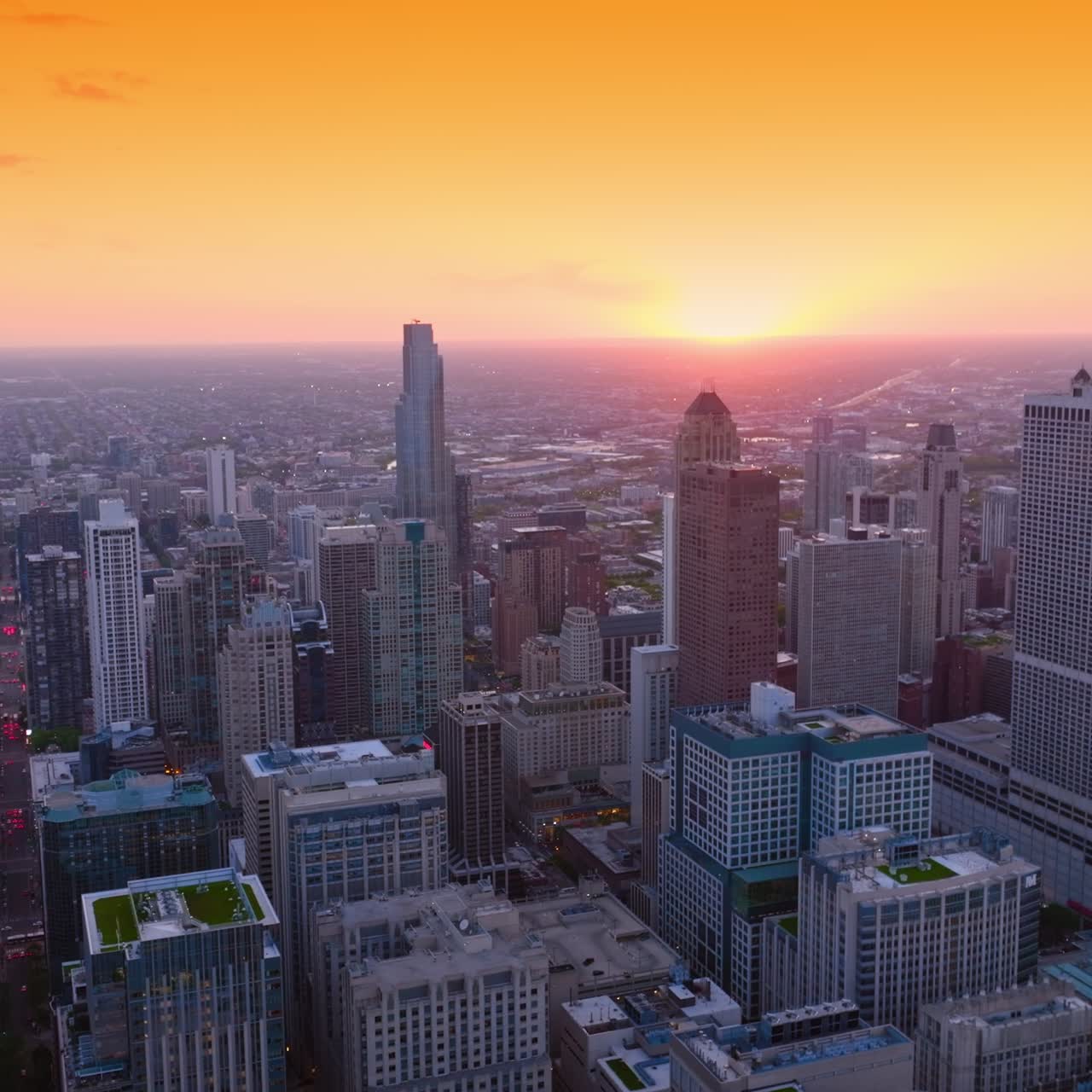 Setting sun at skyline of Chicago, Illinois. Diverse architecture in the fantastic metropolis at sun dusk