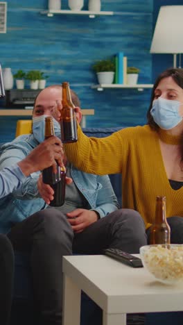 vertical video: diverse group of friends watching tv together comedy sitcom