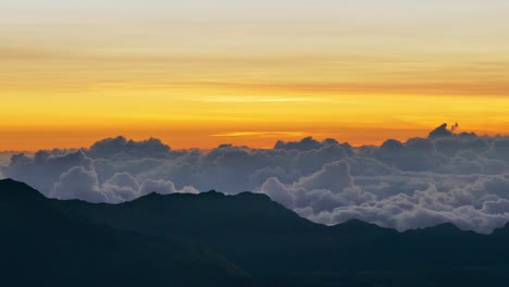 sunrise over a mountain range with clouds