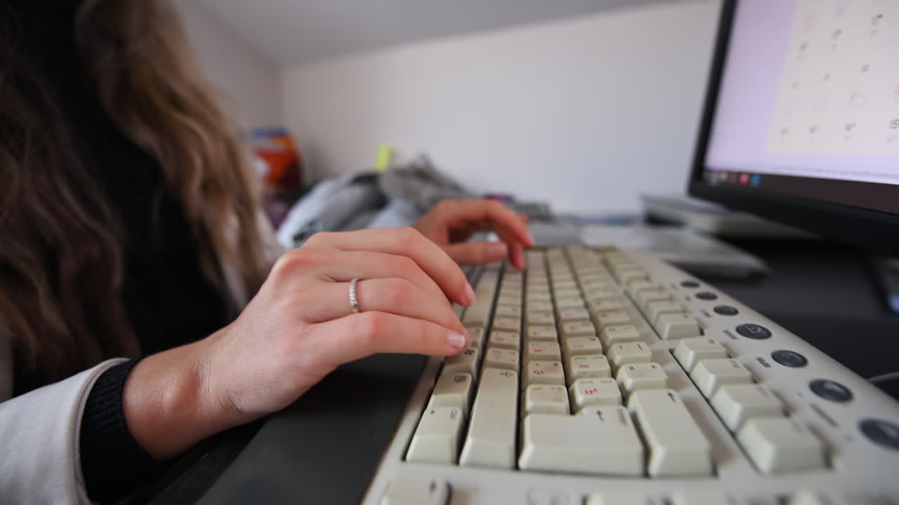 CHISINAU, MOLDOVA - NOVEMBER, 2021: Woman typing on a logitech keyboard at the office