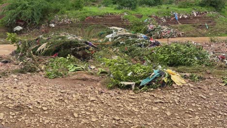 a river affected by flooding and a large amount of waste, including plastic bags and other discarded materials, polluting a body of water or a flood-affected area
