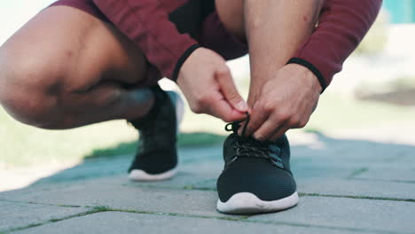 fitness, exercise and hands tie shoes in nature