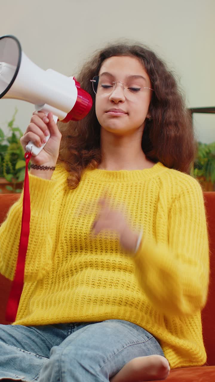 Teenager child girl kid talking with megaphone proclaiming news loudly announcing advertisement