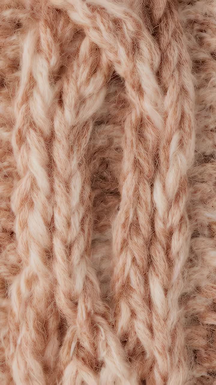 Vertical video: Panning camera moving across ribbed knit macro, showing stitch detail and halo