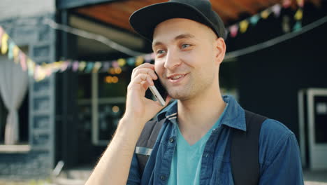 man talking on smartphone outdoors