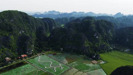 drone flying over the karst mountains in ninh binh, vietnam