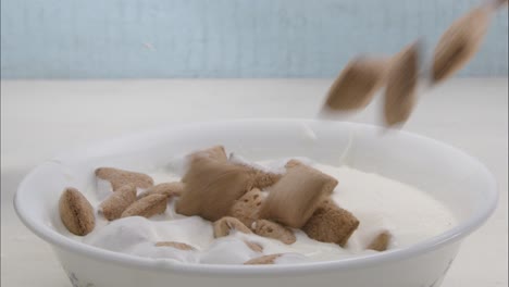 Throwing-many-cereal-snacks-into-a-bowl-full-of-milk