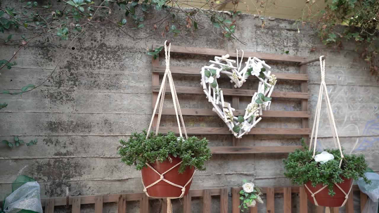 Unique heart-shaped decoration with flowers and natural elements on a rustic wooden backdrop