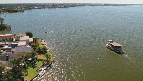 the paddle steamer cumberoona passing the houses on cypress drive mulwala, nsw, australia