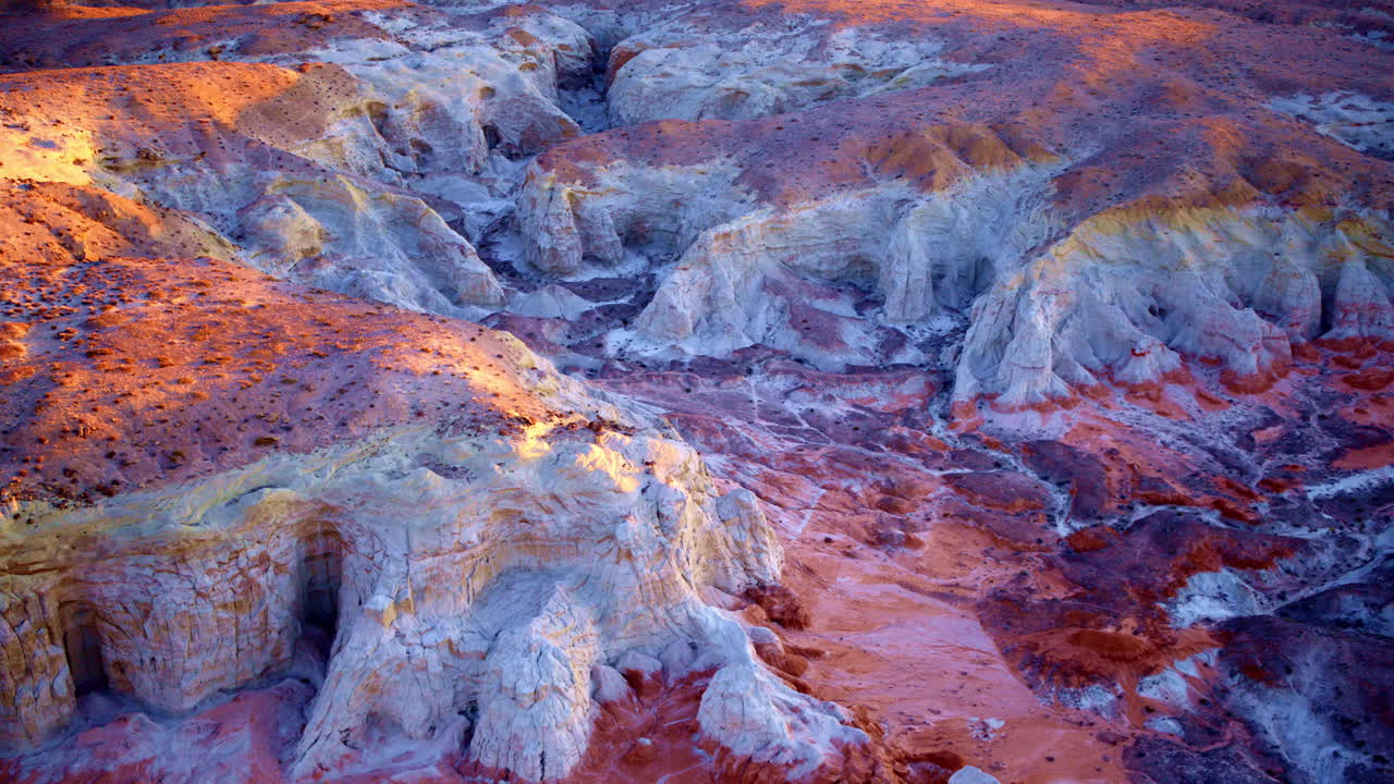 Slow, cinematic drone footage reveals the stunning blend of colorful hills and unusual rock formations near the Utah-Arizona border.