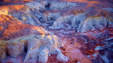 slow, cinematic drone footage reveals the stunning blend of colorful hills and unusual rock formations near the utah-arizona border.