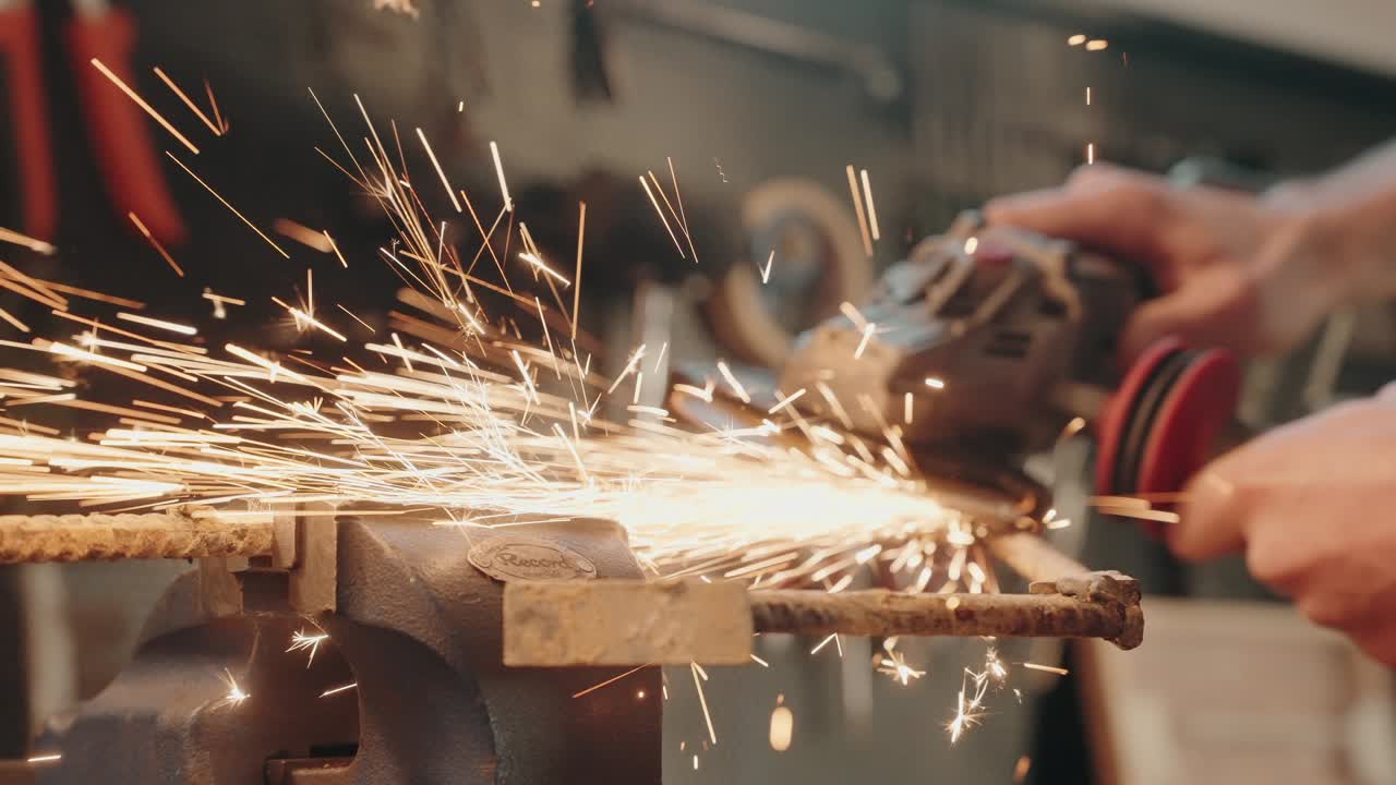 metal grinder cutting rod in slow motion with burst of sparks flying wide