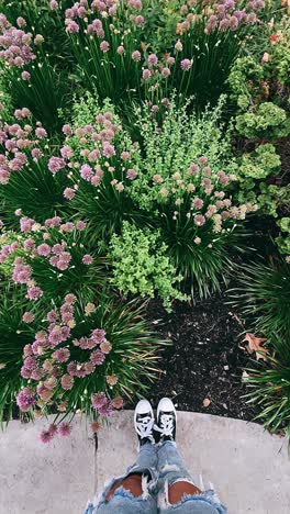 feet in a garden with flowers