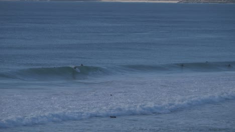 surfers riding the waves - gold coast qld currumbin australia - summer time