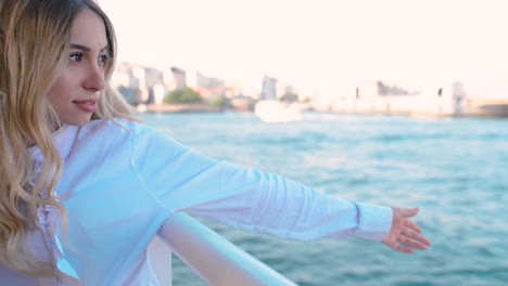 Slow-Motion:Beautiful-girl-enjoys-moment-while-cruising-with-view-of-sea-on-background