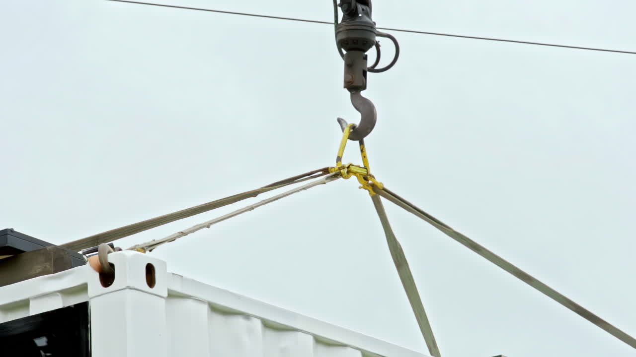 Crane Lifting a Shipping Container with Straps