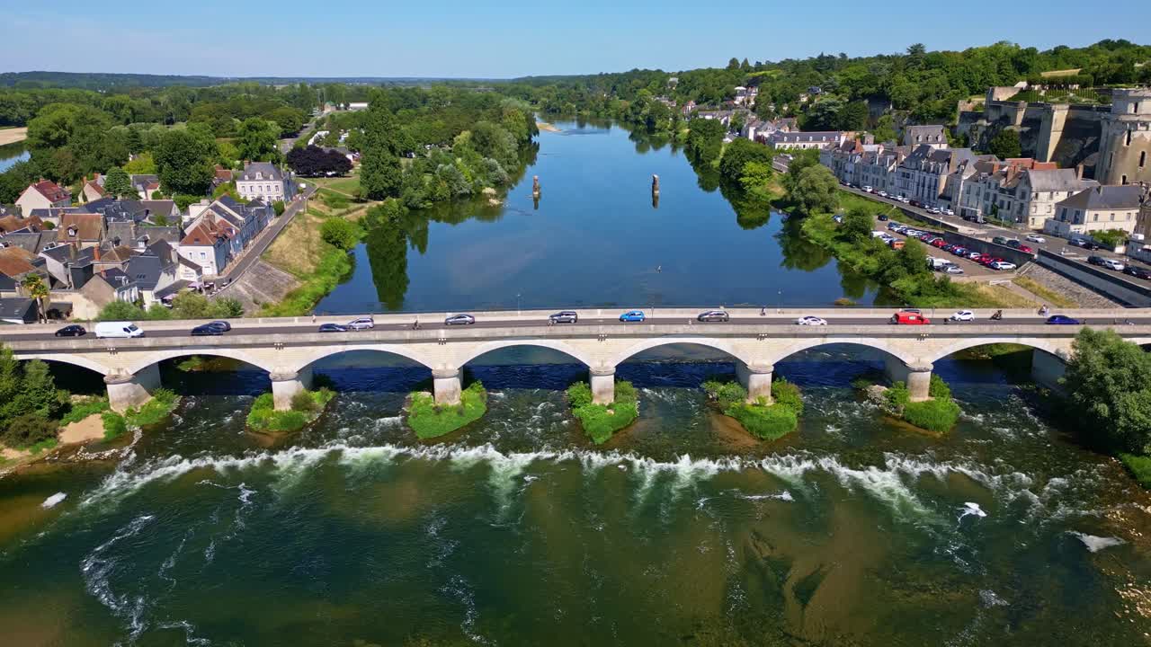 Bridge crossing the Loire near Chateau d’Amboise, green water below, scenic aerial perspective pullback