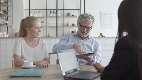 agente de seguros de salud y clientes reunidos en un espacio de trabajo conjunto