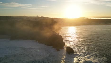 golden hour over rocky coastline, ocean waves crashing at farol de nazaré, portugal