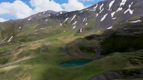 cinematic wide drone shot of oreit lake in tusheti georgia, in the caucasus mountains