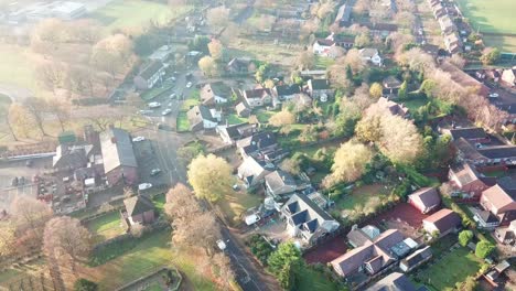 reverse aerial shot above uk rural village - church countryside