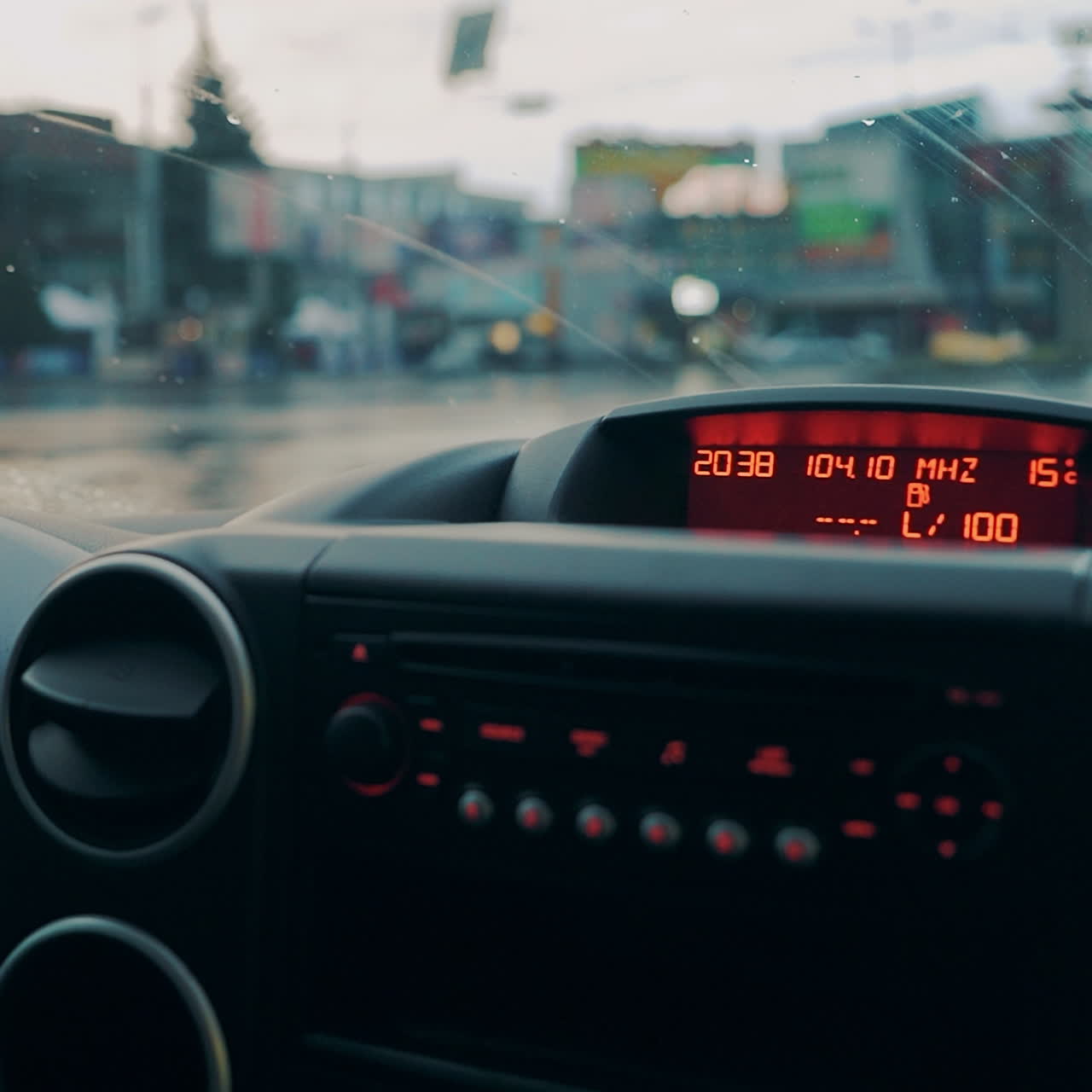 Driving a car in traffic jam in bad weather conditions. Hand of man driving a car. Close-up