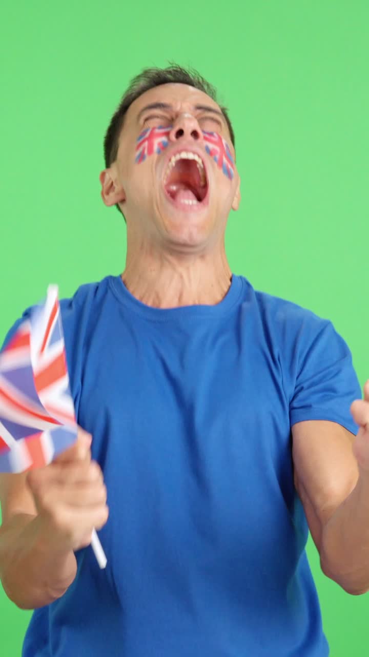 Man cheering for United Kingdom screaming and waving a national flag