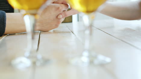 manos de una pareja joven dos copas de vino en primer plano