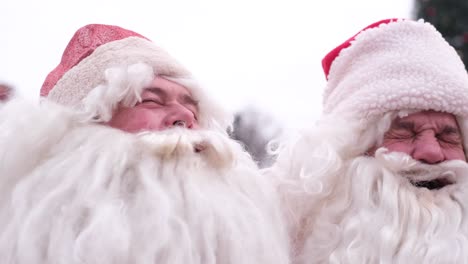 portrait of smiling men in santa claus costumes they look into the camera lens and have fun portrait of smiling men in santa claus costumes they look into the camera lens and have fun merry christmas for the new 2023