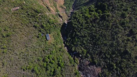 birds eye drone shot of mutarazi falls in zimbabwe - flying over the edge of the waterfall, revealing landscape