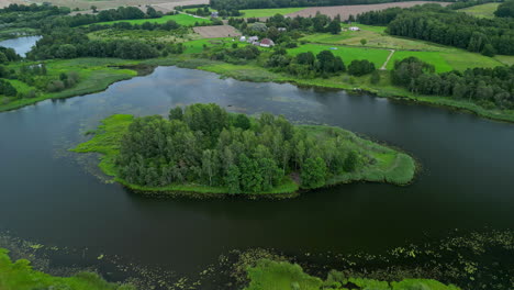 A-forested-island-on-a-lake-in-the-countryside---pullback-aerial-reveal