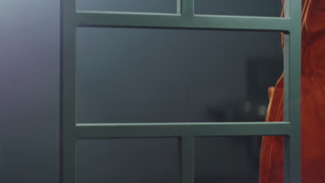 close up of prison guard giving phone to criminal