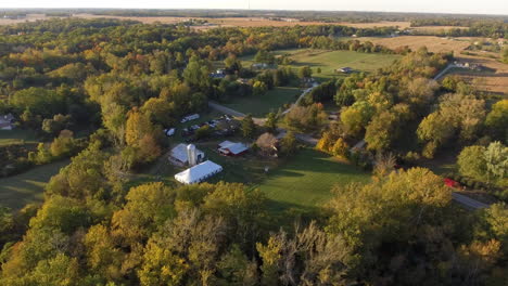 drone shot of outdoor wedding venue in a rural location with fall colors, cinematic rotating aerial shot