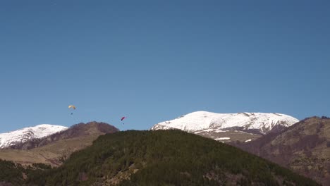 paragliders high in the sunny sky from drone footage 4k