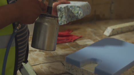 worker washing a piece of concrete block