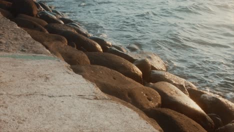 a calm, warm afternoon as tides hit rocks of the old cadiz city port, negros occidental, philippines