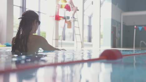 underwater shot of woman swimming in indoor pool