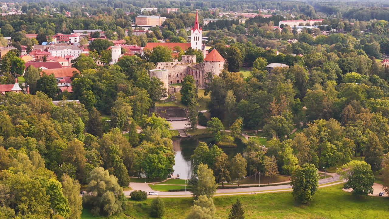 Aerial footage of Cesis Medieval Castle in Latvia, overlooking the historic town and green landscapes.