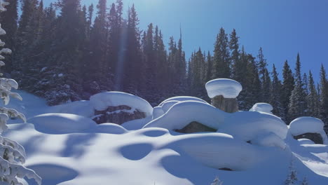 dreamy vail pass colorado backcountry winter cup cakes mushroom pillows aerial drone sunny blue sky fresh deep powder snow snowboard ski snowmobile rock boulder cinematic forward up slowly motion
