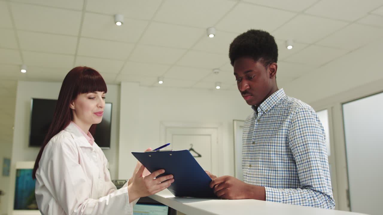 Hospital reception charismatic nurse lady meeting the patient at says where she have to go then