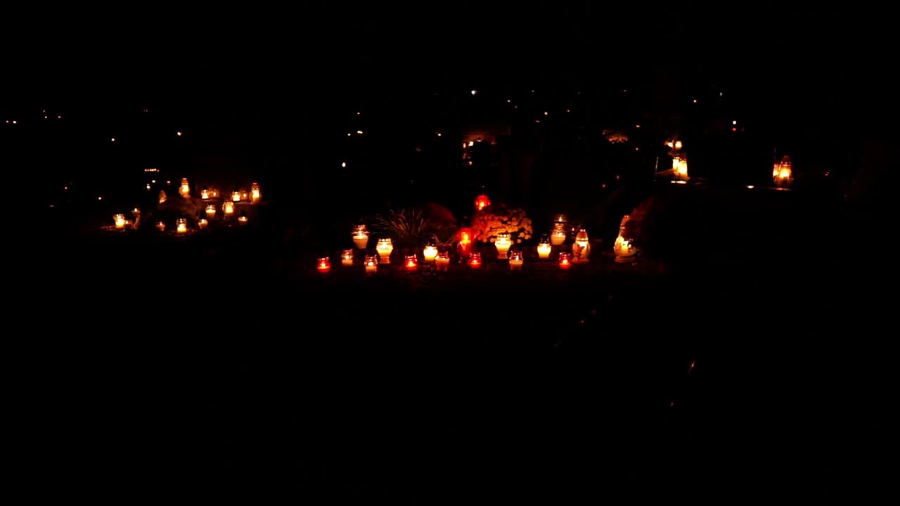 Candles and Lights in a Cemetery at Night