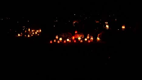 candles and lights in a cemetery at night