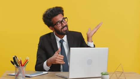 Indian-businessman-looking-at-camera-doing-phone-gesture-says-hey-you-call-me-back-make-conversation