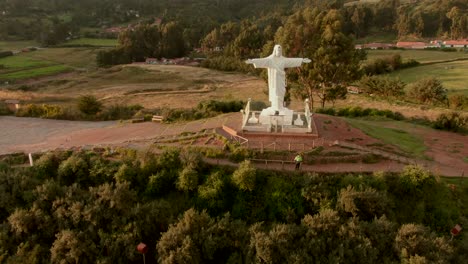 4k daytime before sunset aerial done view over the well known cristo blanco statue in the city of cusco, peru