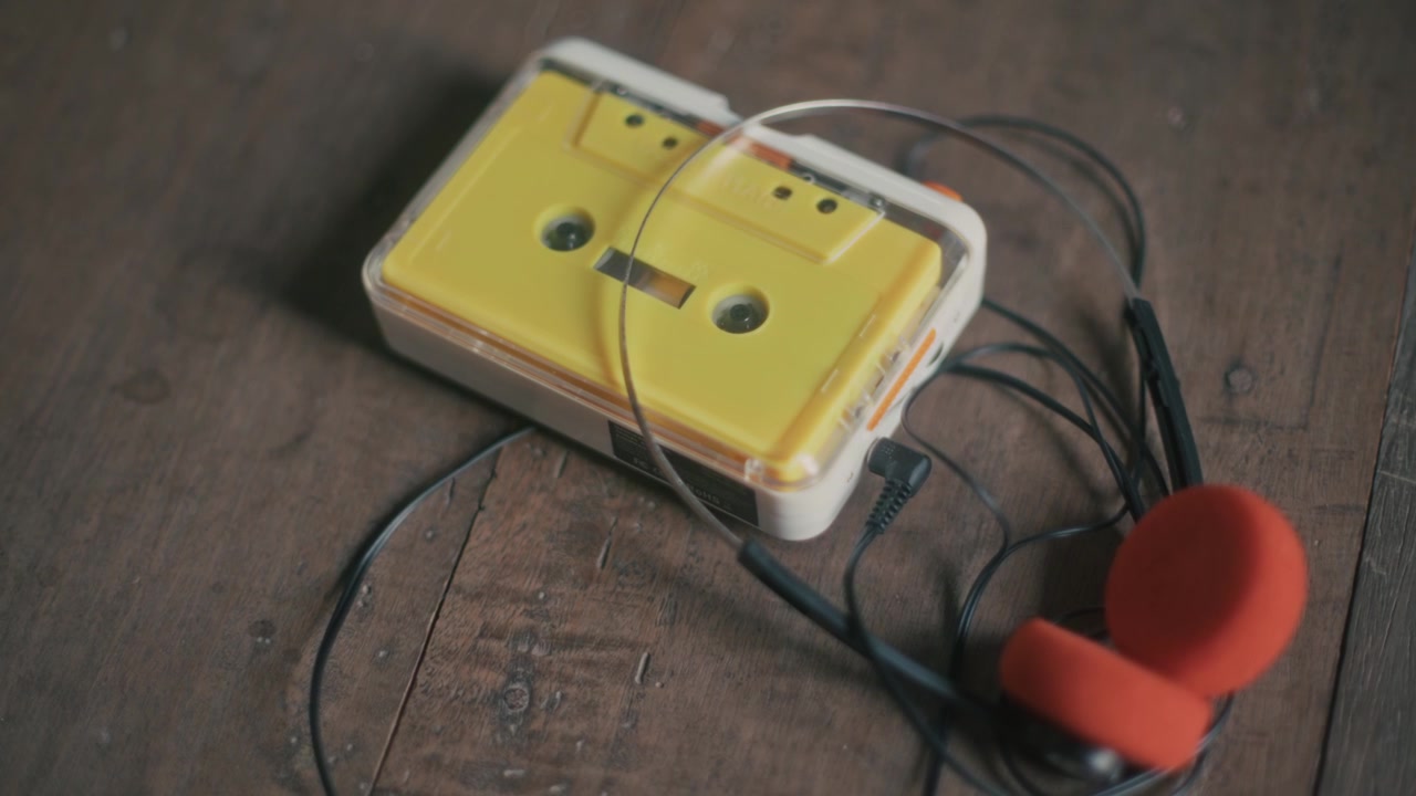 Vintage Yellow Cassette Player with Headphones on Wooden Floor