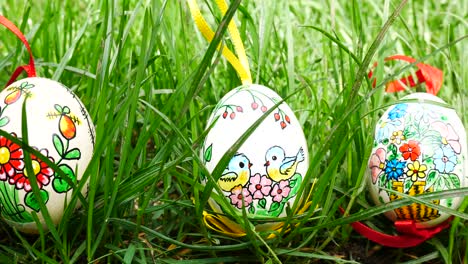 painted easter eggs in the grass. panning.
