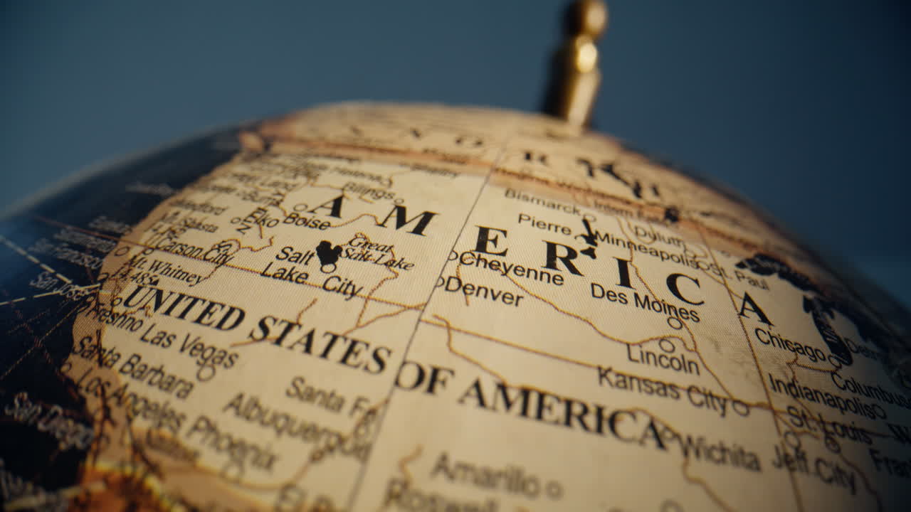 Vintage globe captured closeup inside classroom showing North America mainland