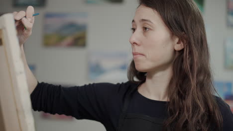 woman painting a picture in an art studio